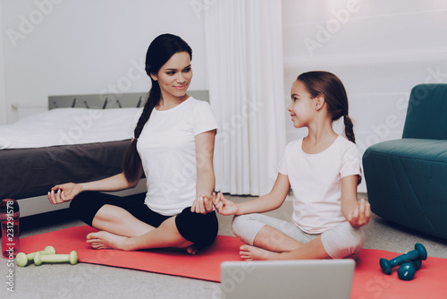 Practice with Young Girl and Mother Yoga at Home.
