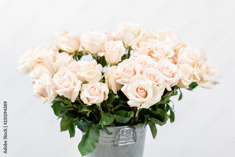 Pastel color. Beautiful light pink roses in bucket on street flower market. Rose flower holiday background. Pastel color. Beautiful light pink roses in bucket on street flower market. Rose flower holiday background.