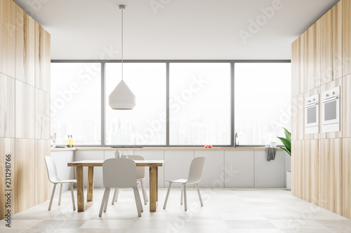 Panoramic white kitchen with wooden table