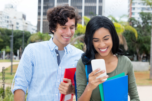 Photography Indian woman with caucasian young adult man and phone