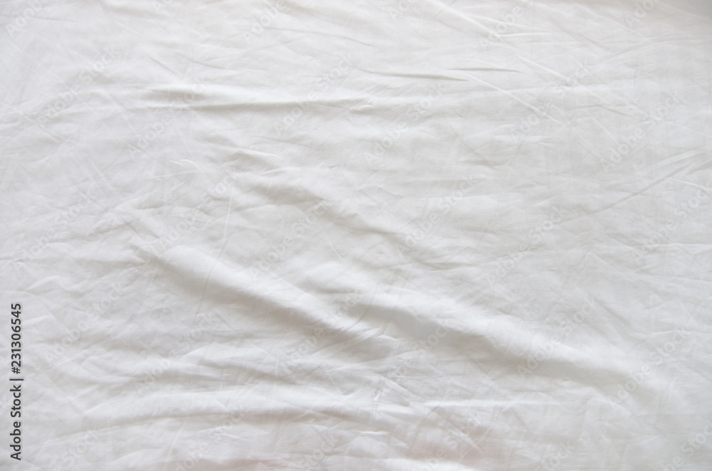 Top view of wrinkles on an unmade bed sheet after waking up in the morning. Top view of wrinkles on an unmade bed sheet after waking up in the morning.