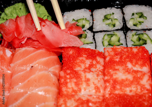 Japanese cuisine. Set of sushi and rolls. Sticks take ginger.