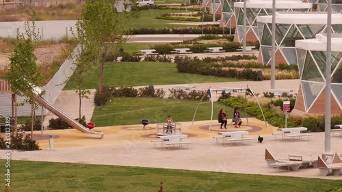 Boy playing on a small caroussel in Parque Felipe VI in  in Logroño, La Rioja, Spain photo