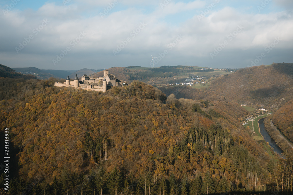Bourscheid castle with autumn colors, cloudy day