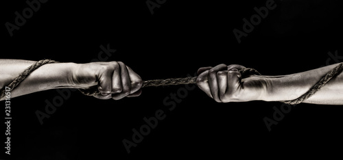 Rope, cord. Hand holding a rope, climbing rope, strength and determination concept. Safety. Macro shot isolated over black background.