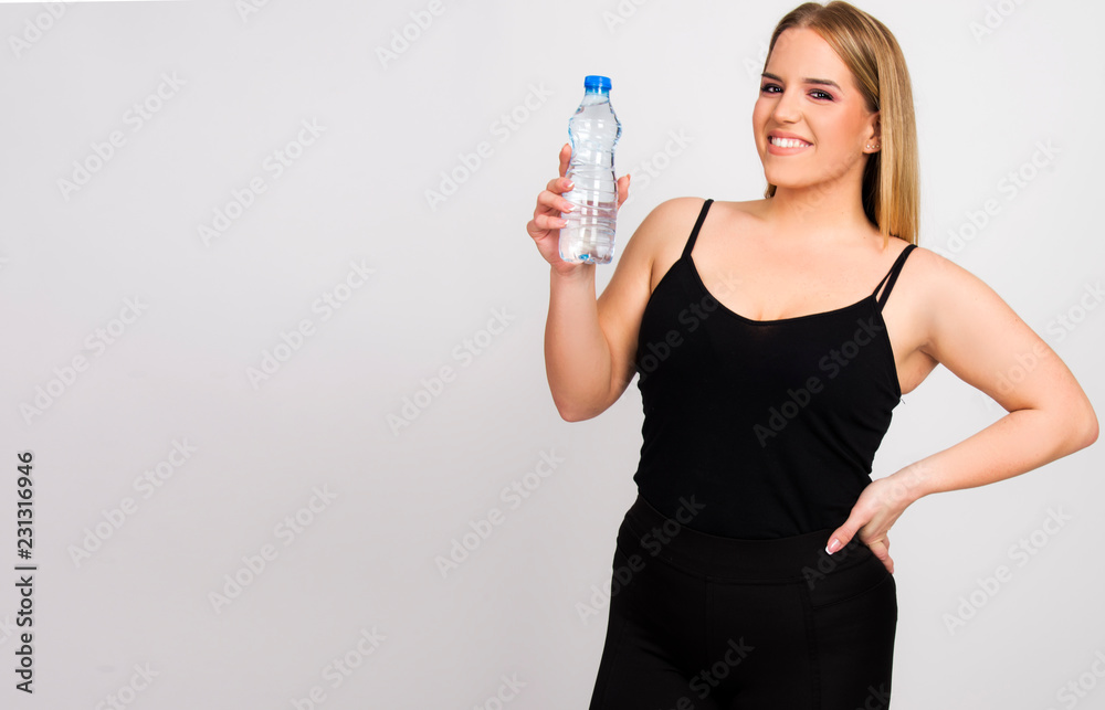 beautiful young woman size plus model holding bottle of water smiling happy healthy lifestyle diet concept beautiful young woman size plus model holding bottle of water smiling happy healthy lifestyle diet concept