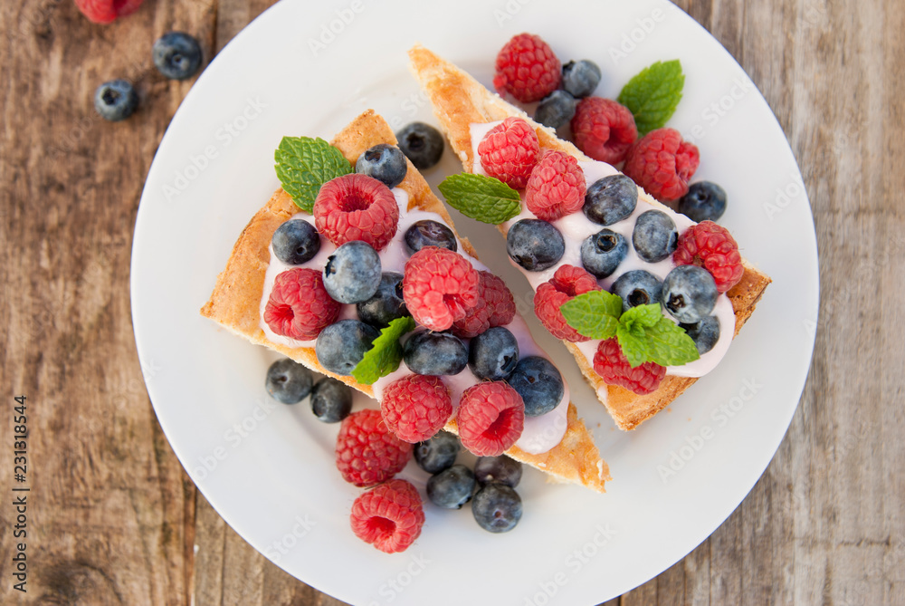 Homemade cheesecake with fresh berries and mint for dessert - healthy organic summer dessert pie cheesecake. Homemade cheesecake with fresh berries and mint for dessert - healthy organic summer dessert pie cheesecake.