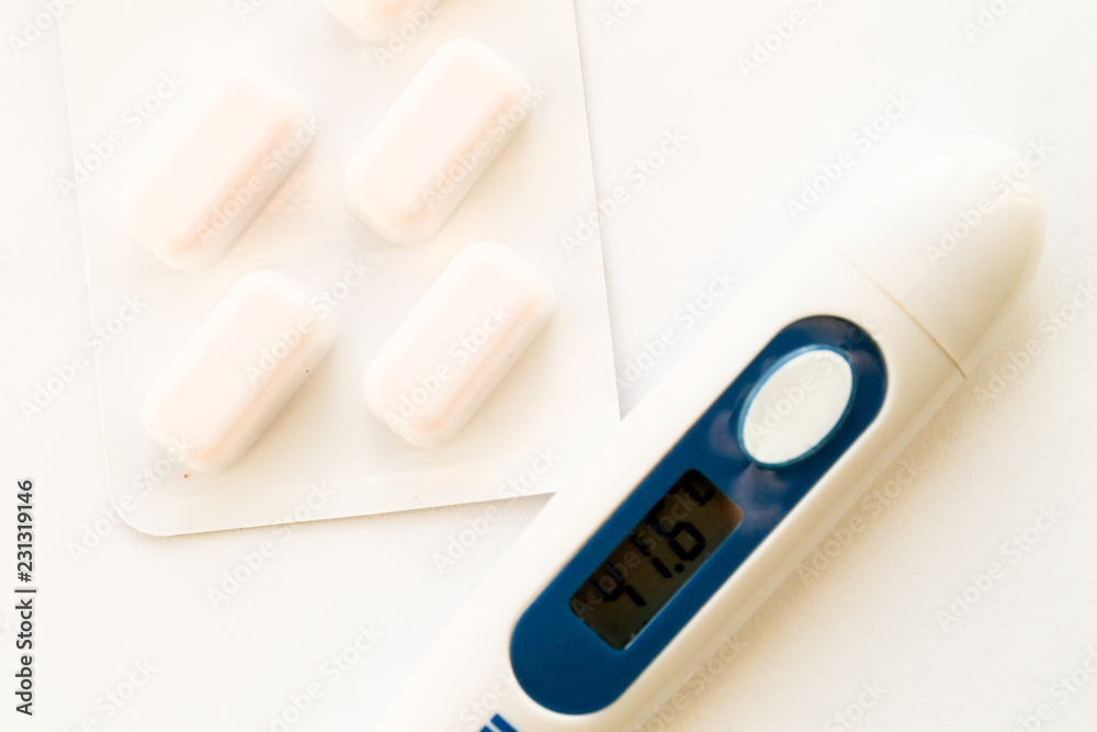 Electric thermometer and pills. Heat.