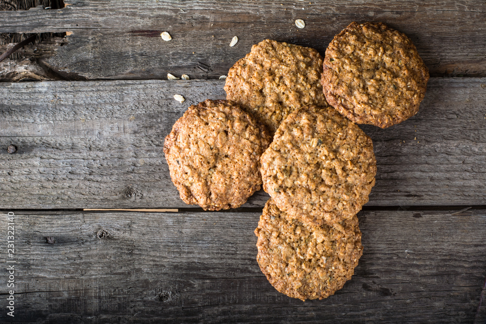 Homemade oatmeal cookies on wooden board on old table background. Healthy Food Snack Concept. Copy space. Milk and cookies. Still life of food. Christmas cookies. Healthy food. Breakfast concept. Homemade oatmeal cookies on wooden board on old table background. Healthy Food Snack Concept. Copy space. Milk and cookies. Still life of food. Christmas cookies. Healthy food. Breakfast concept.