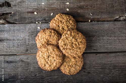 Homemade oatmeal cookies on wooden board on old table background. Healthy Food Snack Concept. Copy space. Milk and cookies. Still life of food. Christmas cookies. Healthy food. Breakfast concept.
