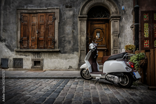 New Vespa Scooter parked in the Italian Street Court - Vacanze Romane