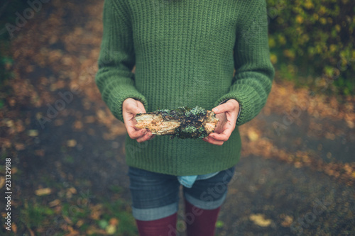 Young owman in nature with lichen covered wood photo