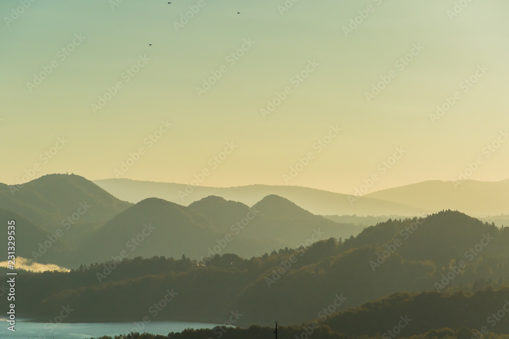 Naklejka premium Ridges of the mountains at sunrise.