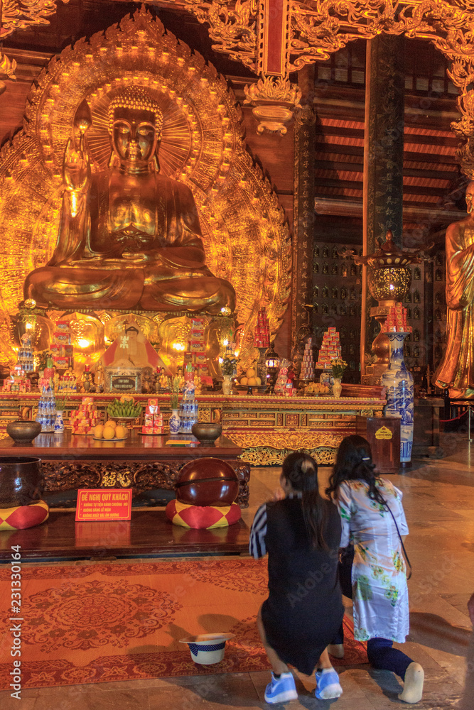 inside of a golden buddhist temple, vietnam