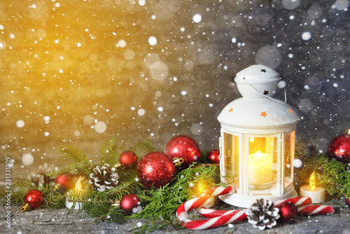 Christmas composition with Shining lentern lights. Red balls, Pine cones, lollipop on Wooden Table photo