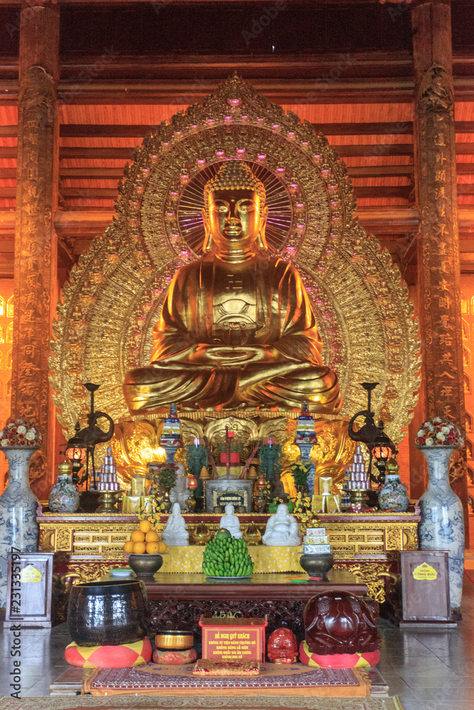 inside of a golden buddhist temple, vietnam