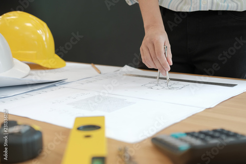 architect engineer working on house blueprint of real estate project at workplace. building construction concept