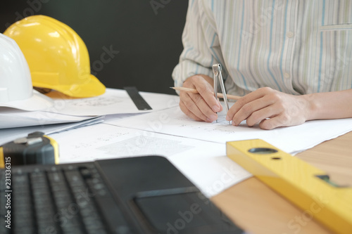 architect engineer working on house blueprint of real estate project at workplace. building construction concept
