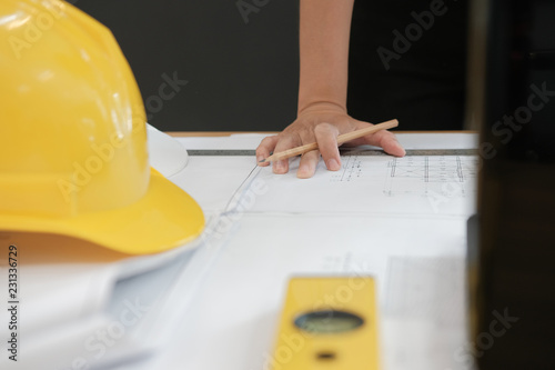 architect engineer working on house blueprint of real estate project at workplace. building construction concept