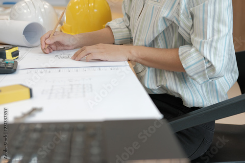 architect engineer working on house blueprint of real estate project at workplace. building construction concept