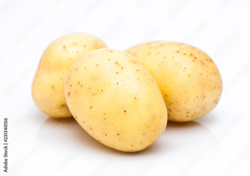 Three healthy organic baby potatoes on white background. Three healthy organic baby potatoes on white background.