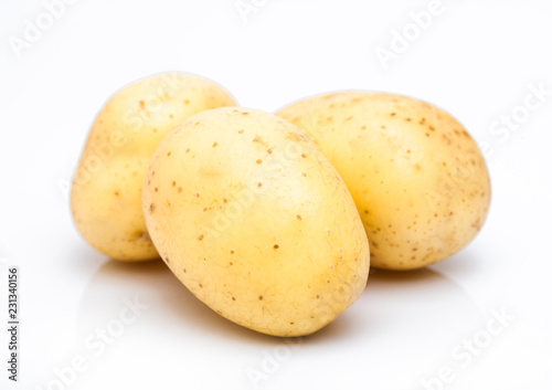 Three healthy organic baby potatoes on white background.