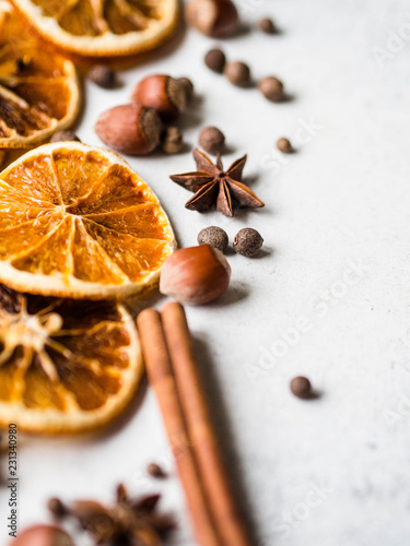 Bright Christmas or New Year background - dry orange slices and spices. Ingredients for making winter seasonal drink - mulled wine. Top view