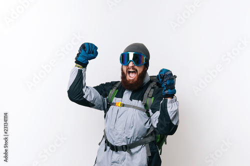 Happy successful hiker celebrating with arms up
