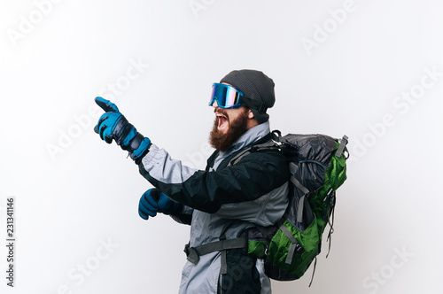 Side view of amazed hiker man pointing away