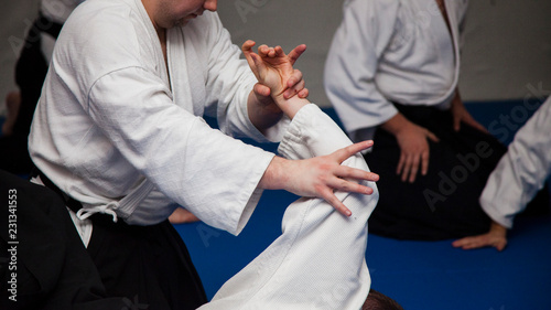 Aikido athletes train in the dojo. Aikidoki work out the elements of aikido equipment 