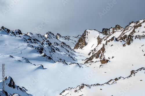 Cold snowy mountain peaks in winter photo
