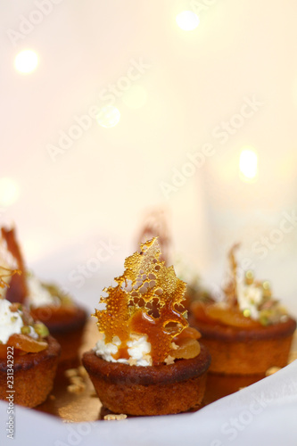 Dried apricot cupcakes with mascarpone frosting, decorated for Christmas. Selective focus. 