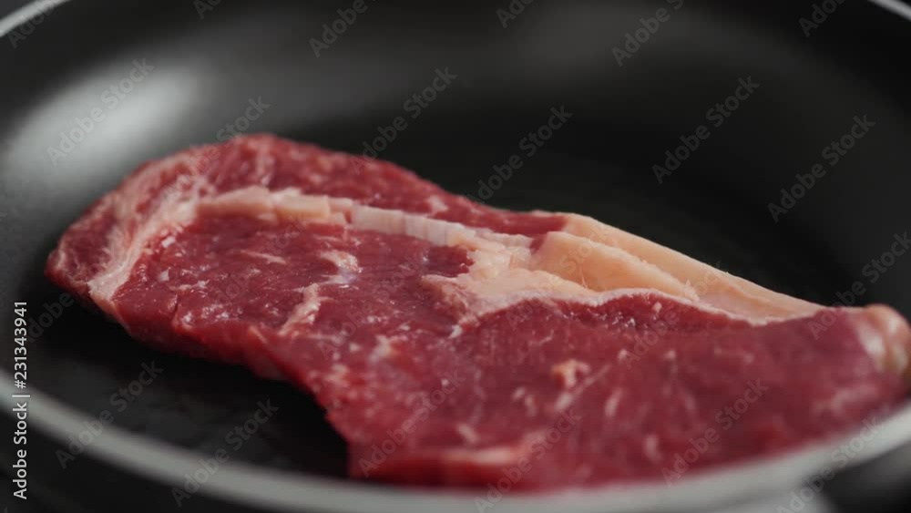 cooking rib eye steak with herbs on grill pan, close up macro pan fresh cooking rib eye steak with herbs on grill pan, close up macro pan fresh