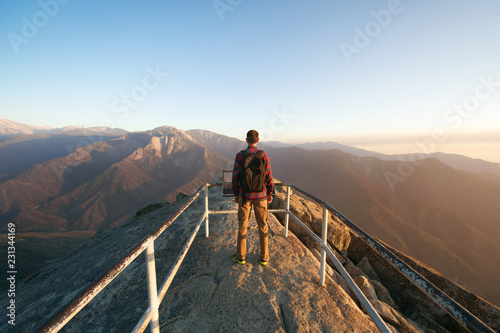 Travel in Sequoia National Park, man Hiker with backpack enjoying view Moro Rock, California, USA photo