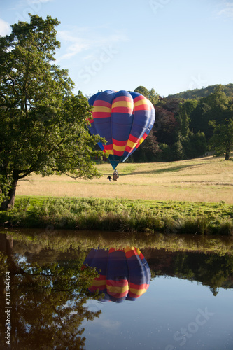 hot air balloon landing in field vertical