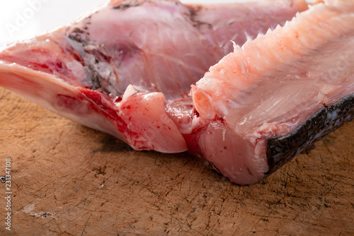 slice of raw fish on chopboard photo