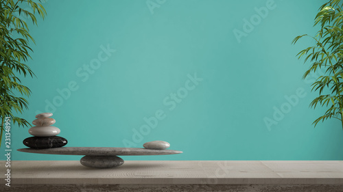 Empty interior design concept, feng shui, zen idea, wooden vintage table or shelf with marble stone balance over ciano turquoise background copy space photo