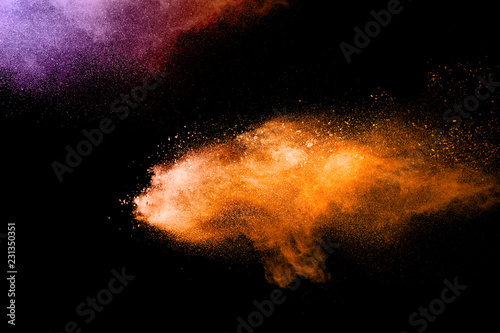 orange dust particles explosion on white background. Powder dust splash.