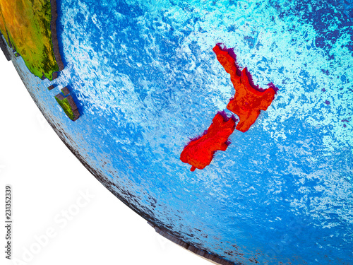 New Zealand on model of Earth with country borders and blue oceans with waves.