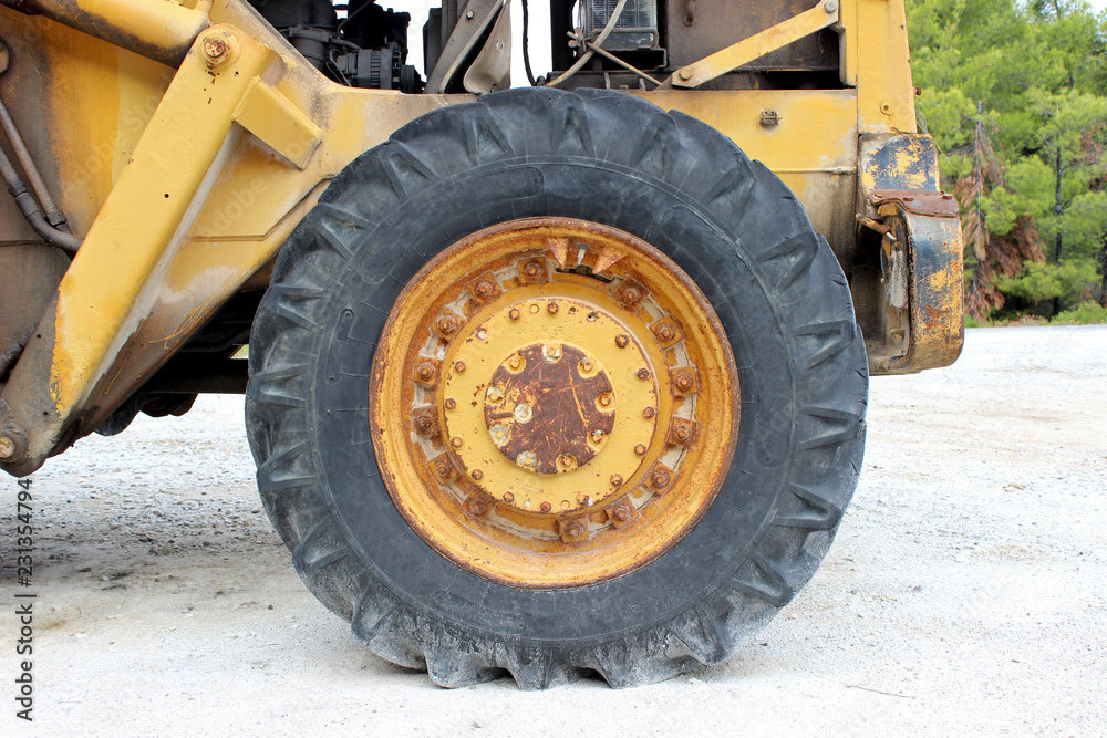 Old yellow loader wheel with tire horizontal Old yellow loader wheel with tire horizontal