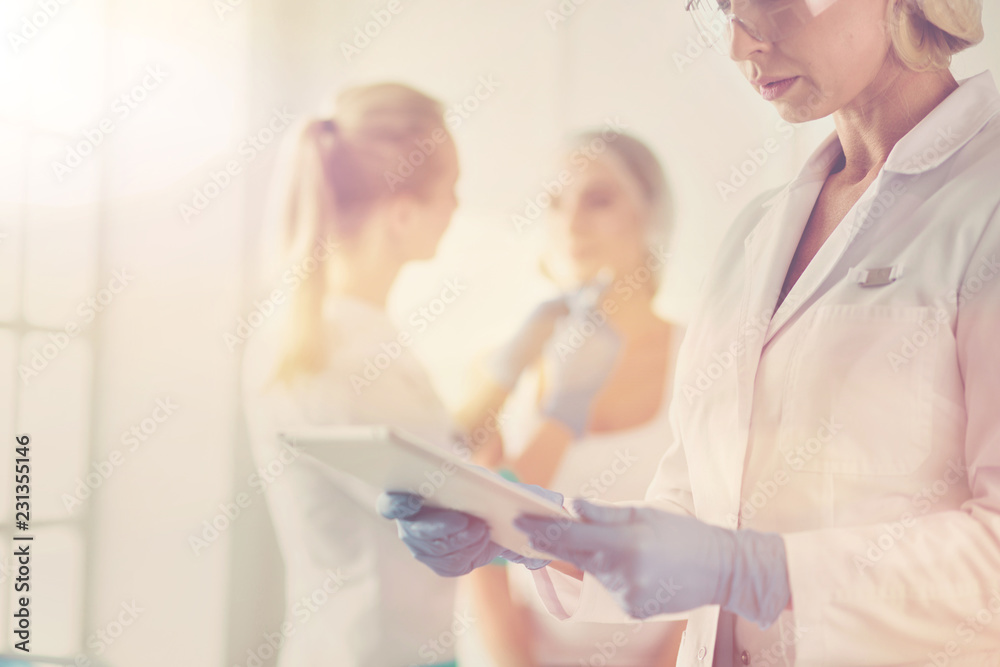 Fototapeta premium Beautiful woman face near doctor with syringe.