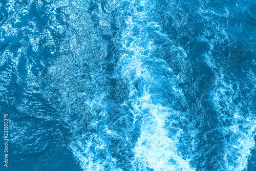 Abstract blue sea water with white foam for background, nature background concept. Toned