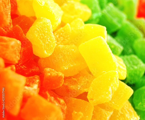 Bright yellow, green and orange candied pineapple fruit slices. 