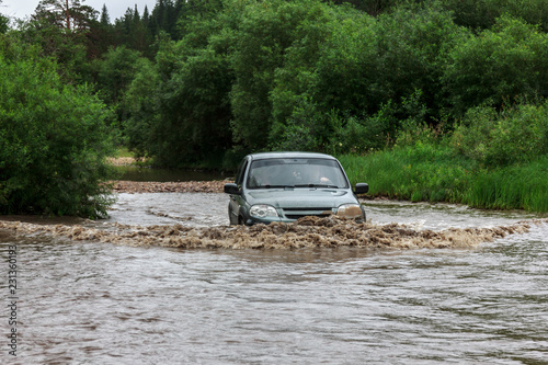 Сar rides on flooded road