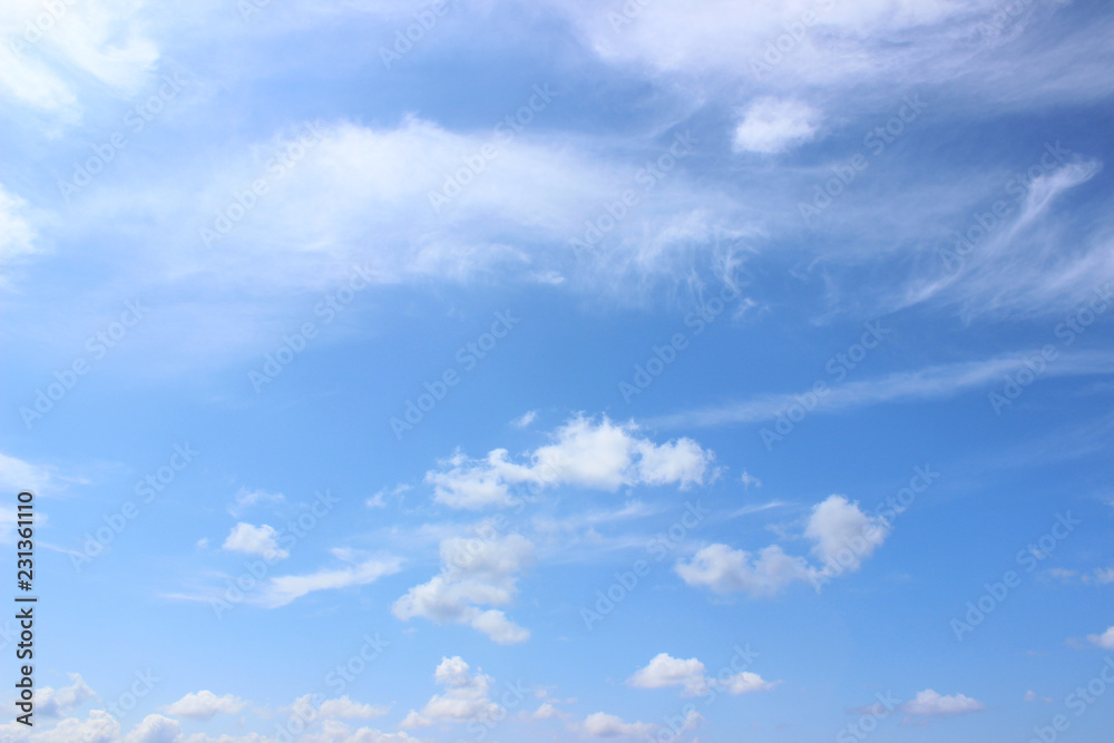 White puffy clouds on blue summer sky