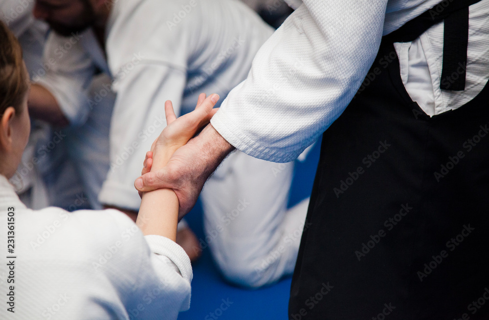 Aikido training. Athletes work out the techniques on each other
Aikido training. Athletes work out the techniques on each other