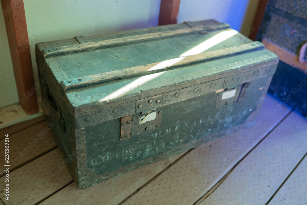 Green military style old wooden chest on the floor. Green military style old wooden chest on the floor.