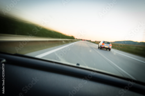 Cars moving fast on a highway (motion blurred image) © lightpoet