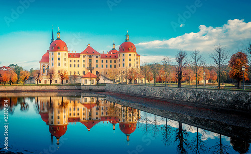 Wonderful Sunny Landscape. Famouse Moritzburg Castle near Dresden lit by the setting sun in the autumn. Saxony, Germany, Europe. Creative image. Awesome nature landscape