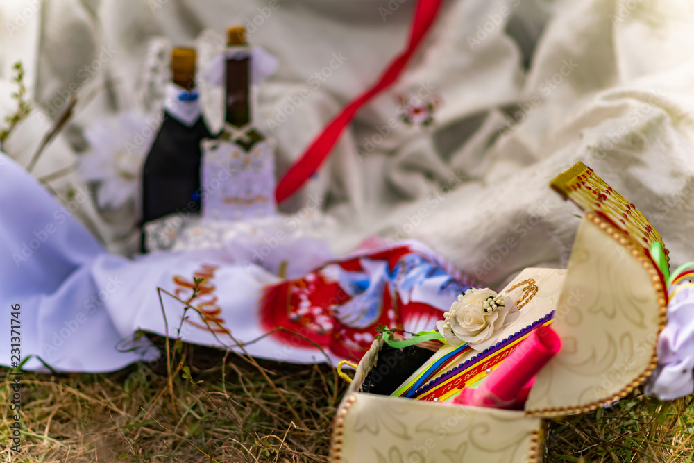 Fototapeta premium Wedding items, composition of festive paraphernalia for the wedding. Colorful scenery in nature, photo for memory. Represents tenderness and romance of the celebration.